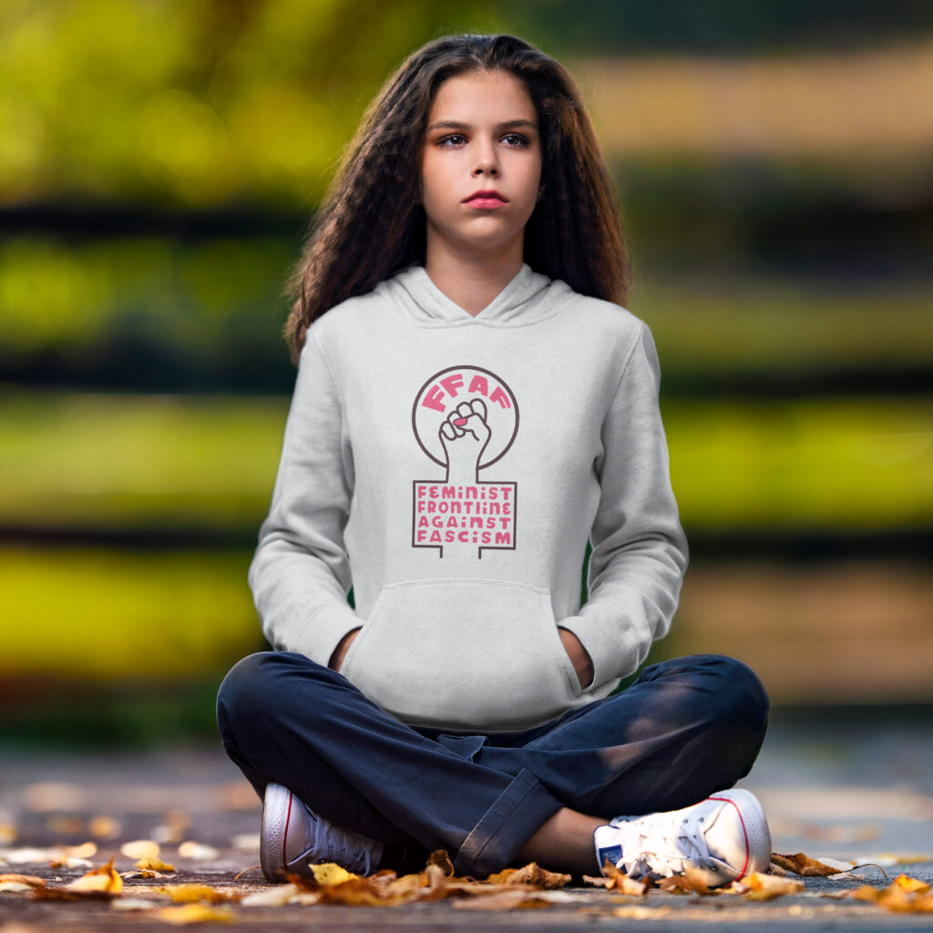 Girl wearing a hoodie printed with the Feminist Frontline Against Fascism SVG design