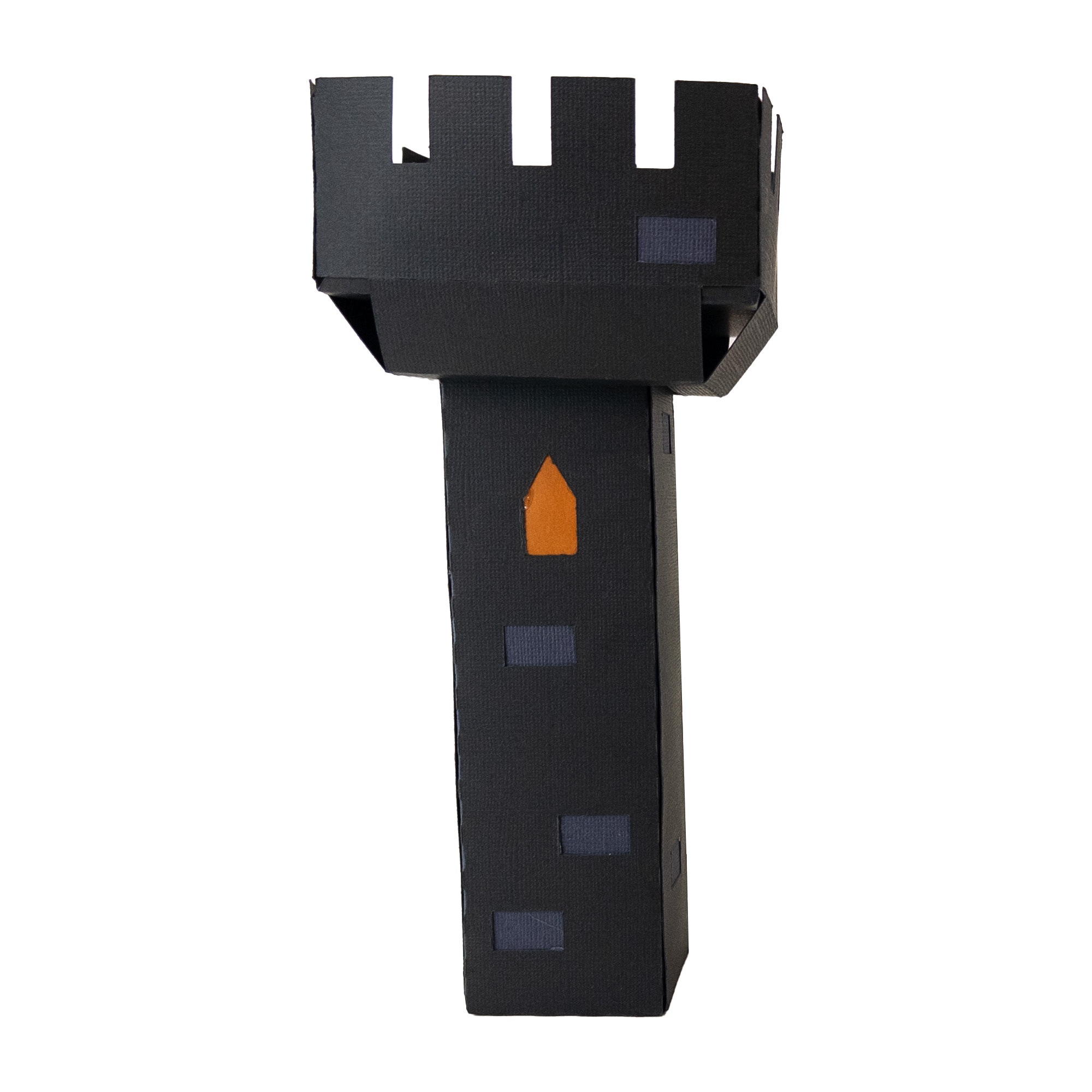 The finished Frankenstein Castle Tall Battlement: a tall, narrow dark gray paper column with a notched battlement crown on top and a single window glowing orange partway up.