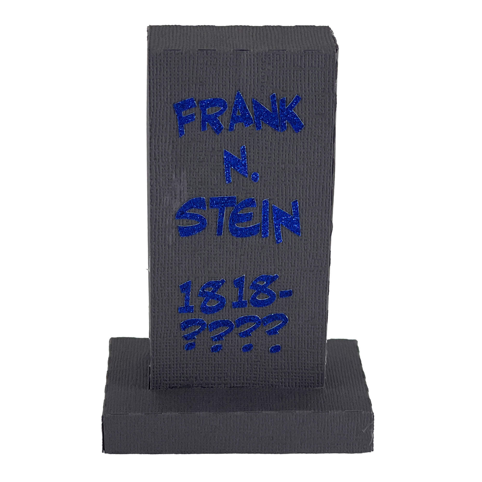 The finished Gravestone 2x4: a tall, narrow dark gray paper gravestone on a low base, lettered in blue vinyl with the name Frank N. Stein and the dates 1818 to a row of question marks.